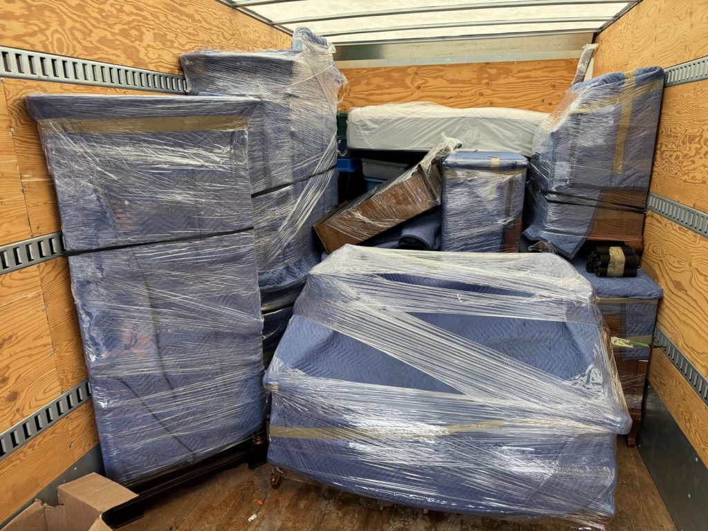 Furniture securely wrapped and loaded into a moving truck for transport