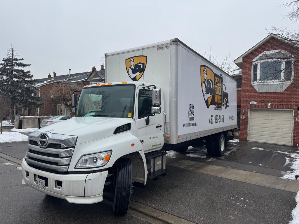 Professional movers carefully loading furniture and boxes during a residential move in Ontario