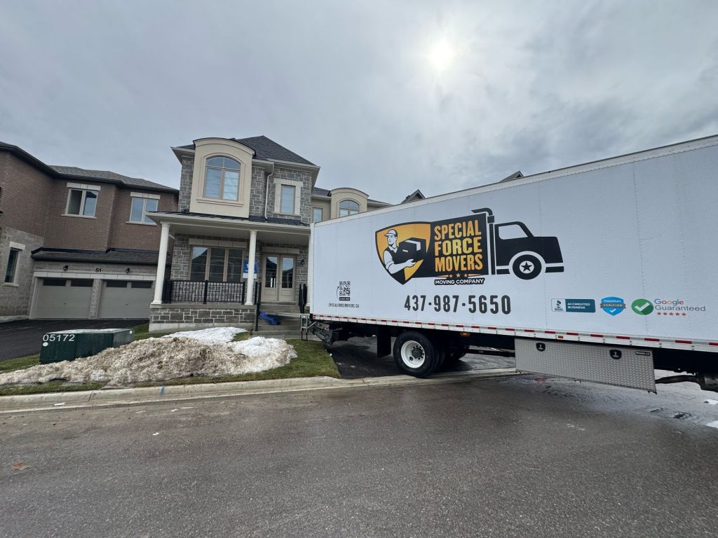 Special Force Movers truck parked outside a residential home