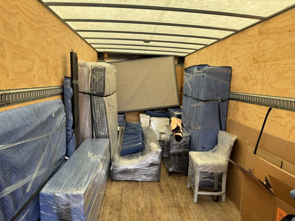 Professional movers loading household furniture into a moving truck in Ontario