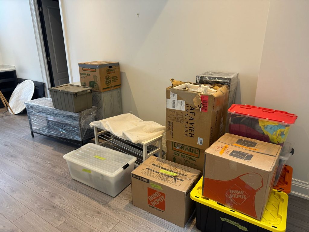 Moving boxes and furniture being loaded into a moving truck in Ontario