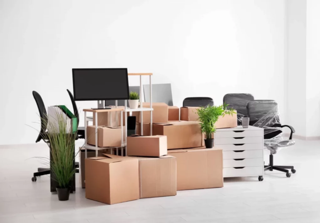 Office furniture and moving boxes prepared for a planned move